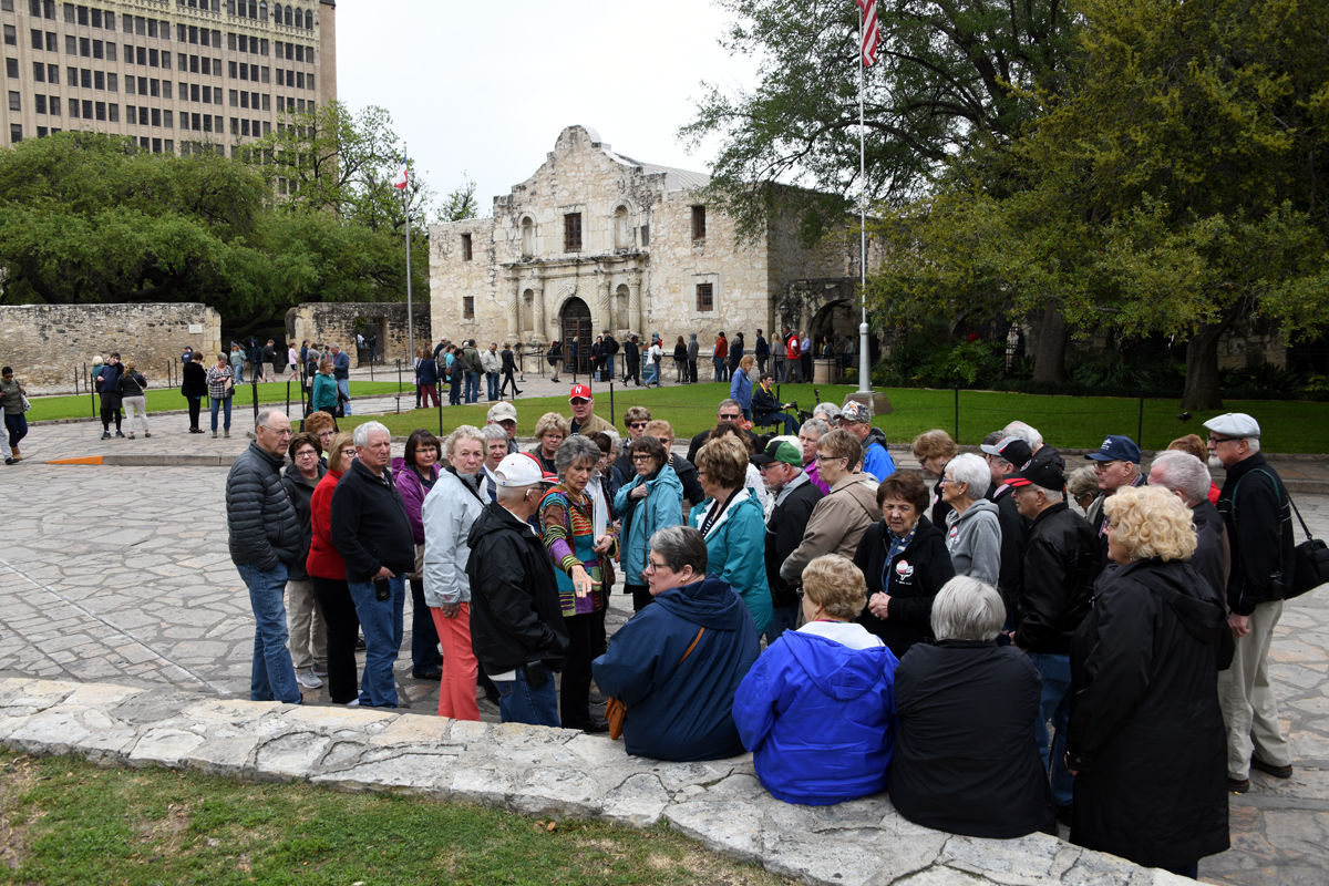 120 Our San Antonio tour guide tells the story of the Alamo.JPG